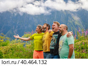 A group of friends are relaxing in the mountains, screaming with pleasure. Mountains of the Caucasus. Russia Ossetia Vladikavkaz August 15, 2020. Редакционное фото, фотограф Юрий Поздников / Фотобанк Лори