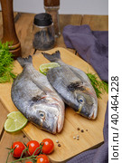 Raw peeled dorado fish with cooking ingredients. Fresh fish on a wooden background. Стоковое фото, фотограф Юрий Поздников / Фотобанк Лори