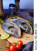 Raw peeled dorado fish with cooking ingredients. Fresh fish on a wooden background. Стоковое фото, фотограф Юрий Поздников / Фотобанк Лори