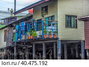 A serene warren of canals, floating houses and stilt houses over the Chao Phraya River, at Krung Thon Bridge (Saphan Sang Hi) (2019 год). Стоковое фото, фотограф Анна Кривицкая / Фотобанк Лори