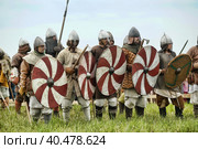 Russia, Staraya Ladoga 23,06,2012 Reenactors with shields and spears during the battle, the festival of historical reconstruction "Pages of History" Стоковое фото, фотограф Анна Кривицкая / Фотобанк Лори
