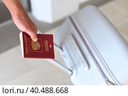 A hand holding Russian passport and suitcase. Стоковое фото, фотограф Татьяна Терехина / Фотобанк Лори