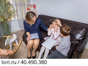 Girl psychologist calms upset girl. The kid is crying. Стоковое фото, фотограф Юрий Поздников / Фотобанк Лори