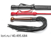 Black and red three bdsm whips on a white background close up. Стоковое фото, фотограф Артем Курутин / Фотобанк Лори