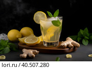 Glass of kombucha with lemons, ginger and mint on black background. Generative AI. Стоковое AI-изображение, AI-художник Александра Селина / Фотобанк Лори