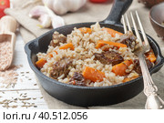 Devzira pilaf with lamb, onions, carrots and spices (cumin, coriander, pepper). Traditional dishes of Uzbek cuisine. Selective focus. Стоковое фото, фотограф Виктория Панченко / Фотобанк Лори