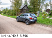Nissan Qashqai vehicle at the countryside. Text in Russian: milk, curd (2020 год). Редакционное фото, фотограф FotograFF / Фотобанк Лори