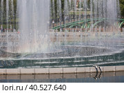 A light and music fountain and a rainbow from the sun on a spring morning. Natural Museum-reserve "Tsaritsyno". Fountain in Tsaritsyno Park. (2023 год). Редакционное фото, фотограф Photojuli / Фотобанк Лори
