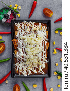 Chilaquiles with chicken and sour cream and sauce on a gray background. Стоковое фото, фотограф Татьяна Терехина / Фотобанк Лори