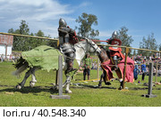 Two knights fight on spears at the festival of historical reconstruction "Russian Fortress" (2014 год). Редакционное фото, фотограф Анна Кривицкая / Фотобанк Лори