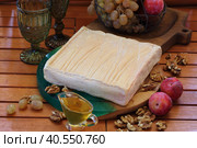 Italian Talleggio cheese with grapes and wine on a wooden background. Стоковое фото, фотограф Марина Володько / Фотобанк Лори