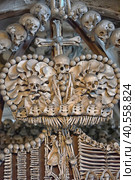 Czech Republic, Kutná Hora, 07,01,2016. Skulls and bones in the ossuary in Kutna Hora. Close up detailed view of Sedlec Ossuary, Church of Bones in Kutna Hora, decorated with real human skeleton bones. Редакционное фото, фотограф Анна Кривицкая / Фотобанк Лори