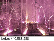 Light and music fountain on a summer evening. Natural Museum-reserve "Tsaritsyno". Colorful fountain in Tsaritsyno Park at night. (2023 год). Редакционное фото, фотограф Photojuli / Фотобанк Лори