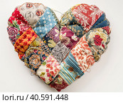 Multicolored pillow made of heart-shaped patches. Created by AI. Стоковое AI-изображение, AI-художник Ярославский Максим / Фотобанк Лори