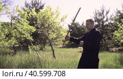 adult tai Chi master demonstrates kung fu skills with a stick. Стоковое видео, видеограф Денис Кебедов / Фотобанк Лори
