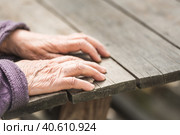 Old wrinkled female hands on a wooden table. Стоковое фото, фотограф Анна Никонорова / Фотобанк Лори