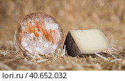 head and chunks of aged hard cheese in hayloft. Стоковое фото, фотограф Татьяна Яцевич / Фотобанк Лори