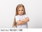 Negative human emotions, reactions and feelings. Isolated shot of moody displeased angry little girl crossing arms on her chest, pouting lips, having offended facial expression, being capricious. Стоковое фото, фотограф Ирина Михайличенко / Фотобанк Лори