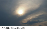 Cirrus clouds cover the disk of the sun with clouds. The disappearance of the sun behind thick dark clouds. Time lapse. Sunbeams in the haze. Sunset for Halloween. Weather forecast. Sky background. Стоковое видео, видеограф Юлия Петровская / Фотобанк Лори