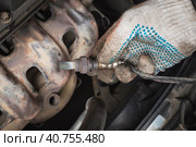 Auto mechanic pulled oxygen sensor or lambda probe for diagnostics at car service station. Стоковое фото, фотограф Сергей Чайко / Фотобанк Лори
