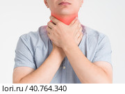 Sore throat, men with pain in neck, gray background. Стоковое фото, фотограф Станислав Тарко / Фотобанк Лори