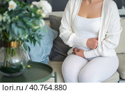 Stomach ache, symptoms of gastritis or pancreatitis, woman with abdominal pain suffering at home. Стоковое фото, фотограф Станислав Тарко / Фотобанк Лори