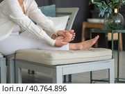 Beauty women's feet with smooth skin in the home interior, foot care and self-massage. Стоковое фото, фотограф Станислав Тарко / Фотобанк Лори
