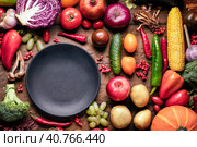 Healthy food concept. fresh fruits and vegetables and an empty black plate on the rustic table. diet raw food and veganism vegetarianism health concept. Стоковое фото, фотограф Владимир Разгуляев / Фотобанк Лори
