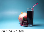 Гранатовый сок в прозрачном бокале с красной трубочкой и сочный гранат крупным планом на светлом фоне. Стоковое фото, фотограф Лозовая Людмила / Фотобанк Лори
