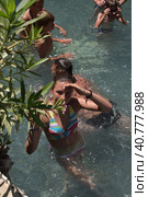 Pammukale, Turkey - July, 19, 2015: People in antique Cleopatra's pool with thermal water in ancient city Hierapolis, near modern Turkey city Denizli. Редакционное фото, фотограф Анна Кривицкая / Фотобанк Лори