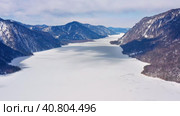 Горный Алтай зимой: Телецкое озеро. Вид с воздуха. Altai mountains in winter: Teletskoye lake. Aerial view. Стоковое видео, видеограф Евгений Романов / Фотобанк Лори
