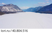 Горный Алтай зимой: Телецкое озеро. Вид с воздуха. Altai mountains in winter: Teletskoye lake. Aerial view. Стоковое видео, видеограф Евгений Романов / Фотобанк Лори