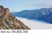 Горный Алтай зимой: Телецкое озеро. Вид с воздуха. Altai mountains in winter: Teletskoye lake. Aerial view. Стоковое видео, видеограф Евгений Романов / Фотобанк Лори
