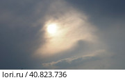Cirrus clouds cover the disk of the sun with clouds. The disappearance of the sun behind thick dark clouds. Sunbeams in the haze. Sunset for Halloween. Weather forecast. Sky background. Стоковое видео, видеограф Юлия Петровская / Фотобанк Лори