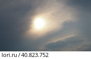 Cirrus clouds cover the disk of the sun with clouds. The disappearance of the sun behind thick dark clouds. Sunbeams in the haze. Sunset for Halloween. Weather forecast. Sky background. Стоковое видео, видеограф Юлия Петровская / Фотобанк Лори
