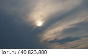 Cirrus clouds cover the disk of the sun with clouds. The disappearance of the sun behind thick dark clouds. Sunbeams in the haze. Sunset for Halloween. Weather forecast. Sky background. Стоковое видео, видеограф Юлия Петровская / Фотобанк Лори