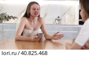 Upset daughter and angry mother talking crossly to each other standing in the kitchen. Стоковое видео, видеограф Яков Филимонов / Фотобанк Лори