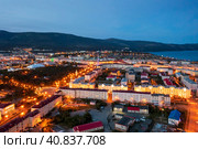 Night aerial photograph of a seaside port town. Top view of illuminated streets and buildings. Mountains and sea in the distance. City of Magadan, Magadan region, Far East of Russia. Стоковое фото, фотограф Андрей Степанов / Фотобанк Лори