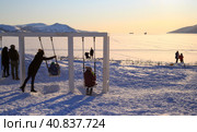 Magadan, Russia. Swing on the sea coast. Family holiday. People admire the beautiful sea view. Children have fun on the swings. Good mood. Nagaev Bay, Magadan, Siberia, Russia. Редакционное фото, фотограф Андрей Степанов / Фотобанк Лори