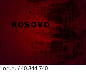 Kosovo inscription on a red-black background. Blood shade. The Republic of Kosovo is a partially recognized state in the Balkans, or part of Serbia. Concept of armed conflict, politics and separatism. Стоковое фото, фотограф Юлия Петровская / Фотобанк Лори