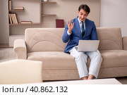 Young male employee working from home during pandemic. Стоковое фото, фотограф Elnur / Фотобанк Лори