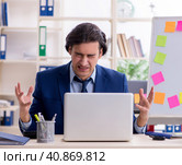 Young male employee unhappy with excessive work. Стоковое фото, фотограф Elnur / Фотобанк Лори