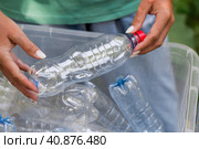 Container of plastic bottles. Garbage collection around the world. Clean the planet of plastic garbage. Ecology. A woman sorts garbage. Стоковое фото, фотограф Photojuli / Фотобанк Лори