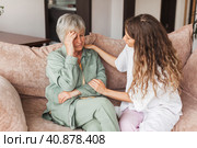 Grown up daughter soothe aged mother holds her hand feel empathy give her moral support, sad elderly woman at home. Стоковое фото, фотограф Гладских Татьяна / Фотобанк Лори