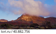 Sunset clouds above Teide National Park in Tenerife. The Volcano cannot be seen because it is inside. Стоковое видео, видеограф Ольга Сухарева / Фотобанк Лори