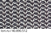 Video of fragment of knitted sweater. Textile background from loops of gray and white wool from knitted stripes. Warm knitted cozy clothes. Flat lay, macro, top view, mockup, close-up. Стоковое видео, видеограф Виктория Катьянова / Фотобанк Лори