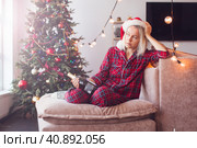 Sad lonely middle aged woman complaining in christmas sitting on couch. Стоковое фото, фотограф Гладских Татьяна / Фотобанк Лори
