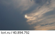 Cirrus clouds cover the disk of the sun with clouds. The disappearance of the sun behind thick dark clouds. Sunbeams in the haze. Sunset for Halloween. Weather forecast. Sky background. Стоковое видео, видеограф Юлия Петровская / Фотобанк Лори