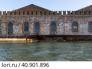 An ancient brick wall of red brick with arch windows and details in the sea by the water front view. Стоковое фото, фотограф Kolotnev Nikita / Фотобанк Лори