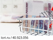 Toy shopping cart with Russian rubles money. Living wage and purchasing power concept. Стоковое фото, фотограф Сергей Толмачёв / Фотобанк Лори